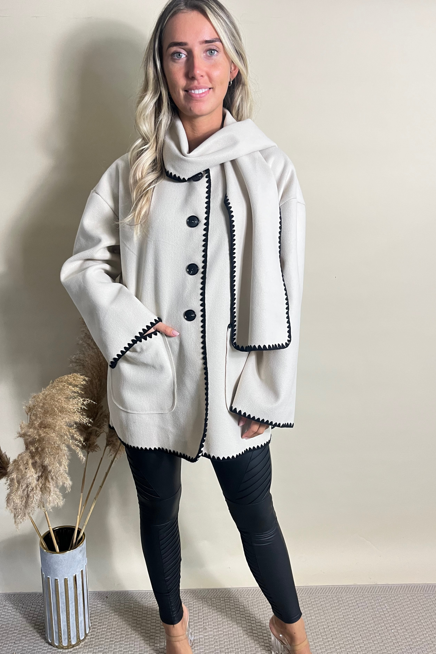 Cream jacket and scarf with contrasting black stitching