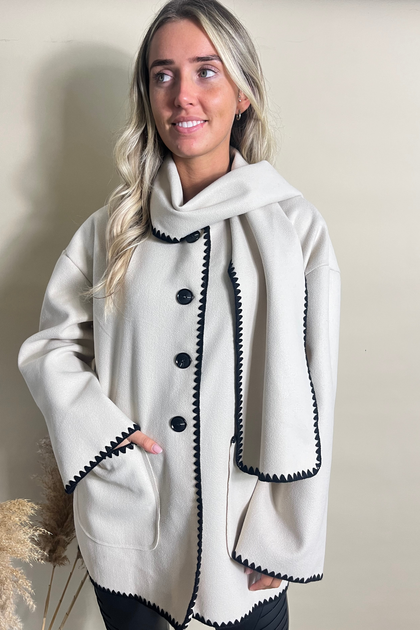 Cream jacket and scarf with contrasting black stitching