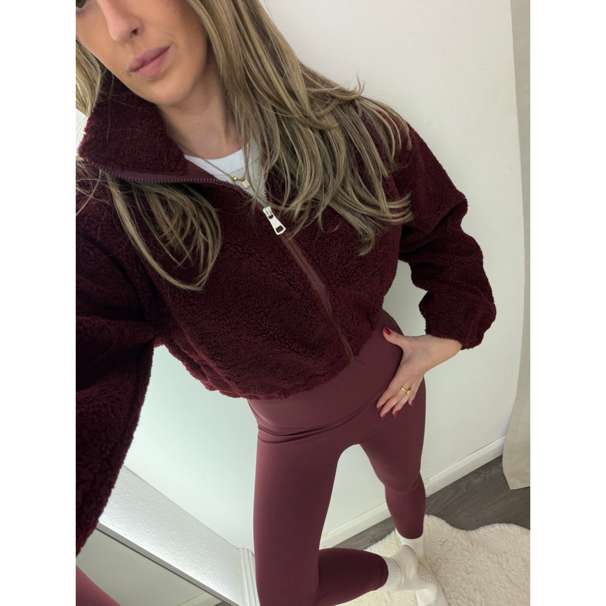 Close-up of the Burgundy Cropped Borg Fleece Jacket and Plum Energy Leggings waistband