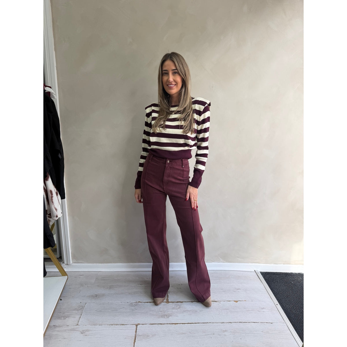 Burgundy and cream striped padded shoulder jumper styled with burgundy wide-leg trousers