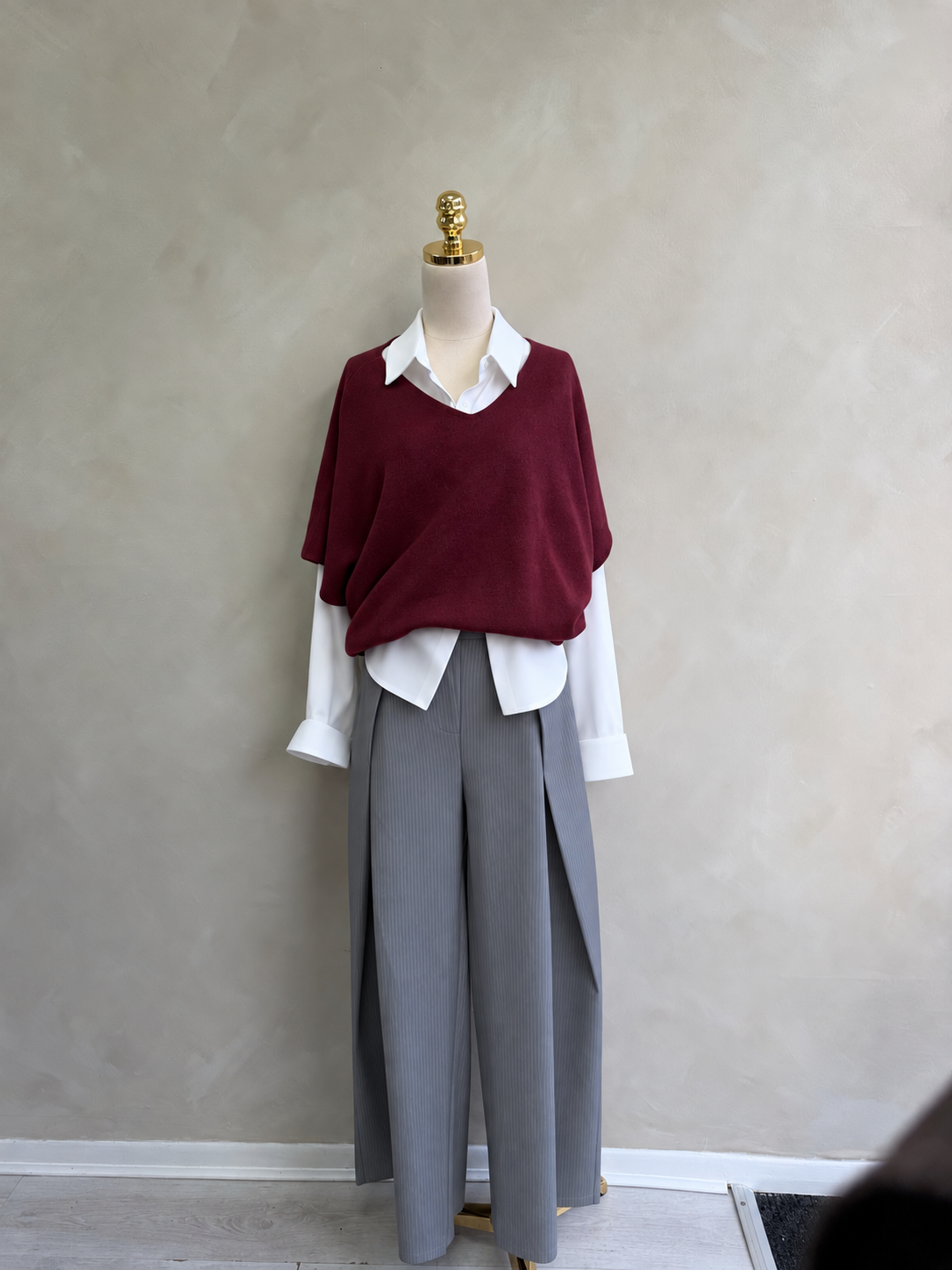 Burgundy soft knit layered with white shirt and pinstripe trousers